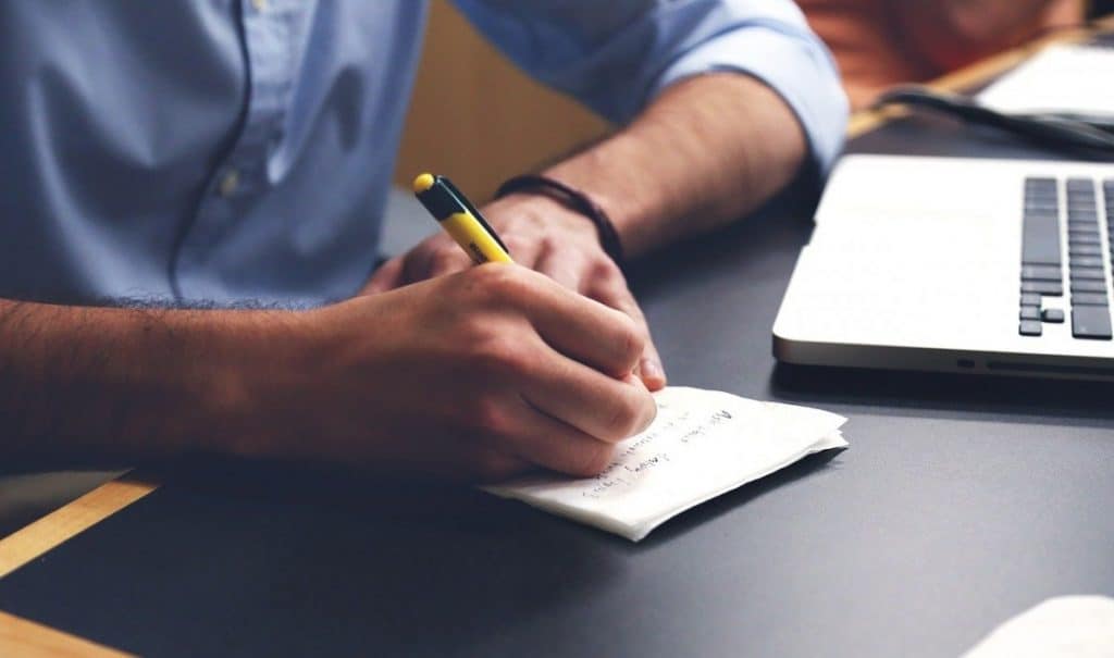 writer writing in notebook